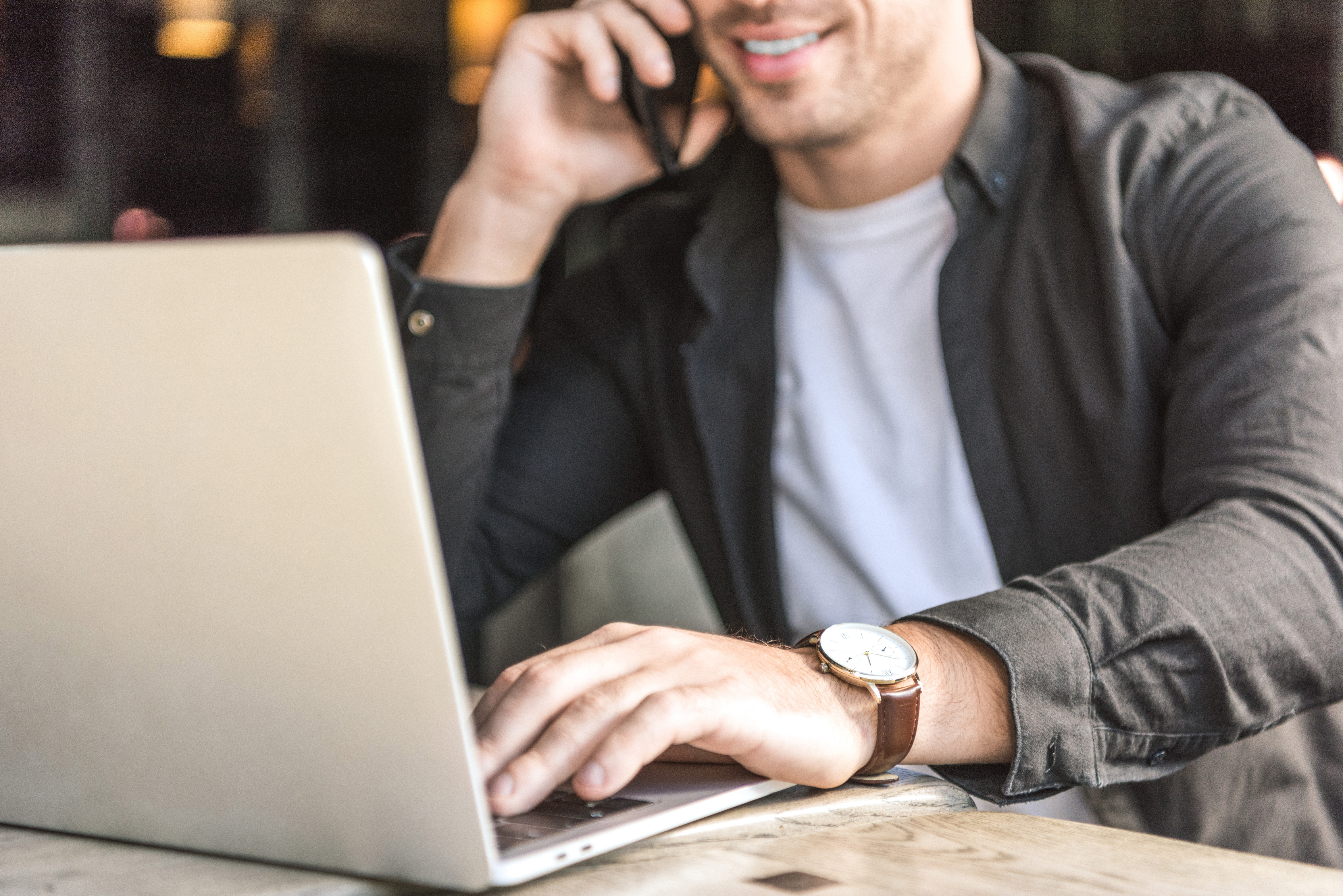 Man on phone and laptop using marketing personalisation