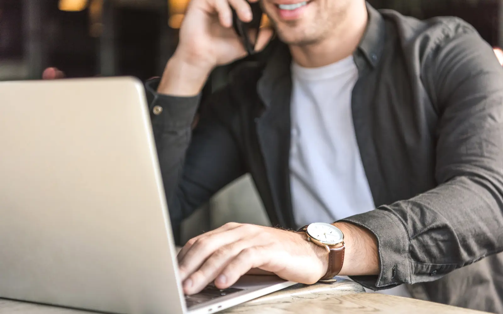 Man on phone and laptop using marketing personalisation