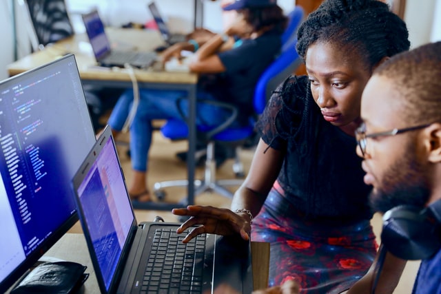 a woman looking at a laptop