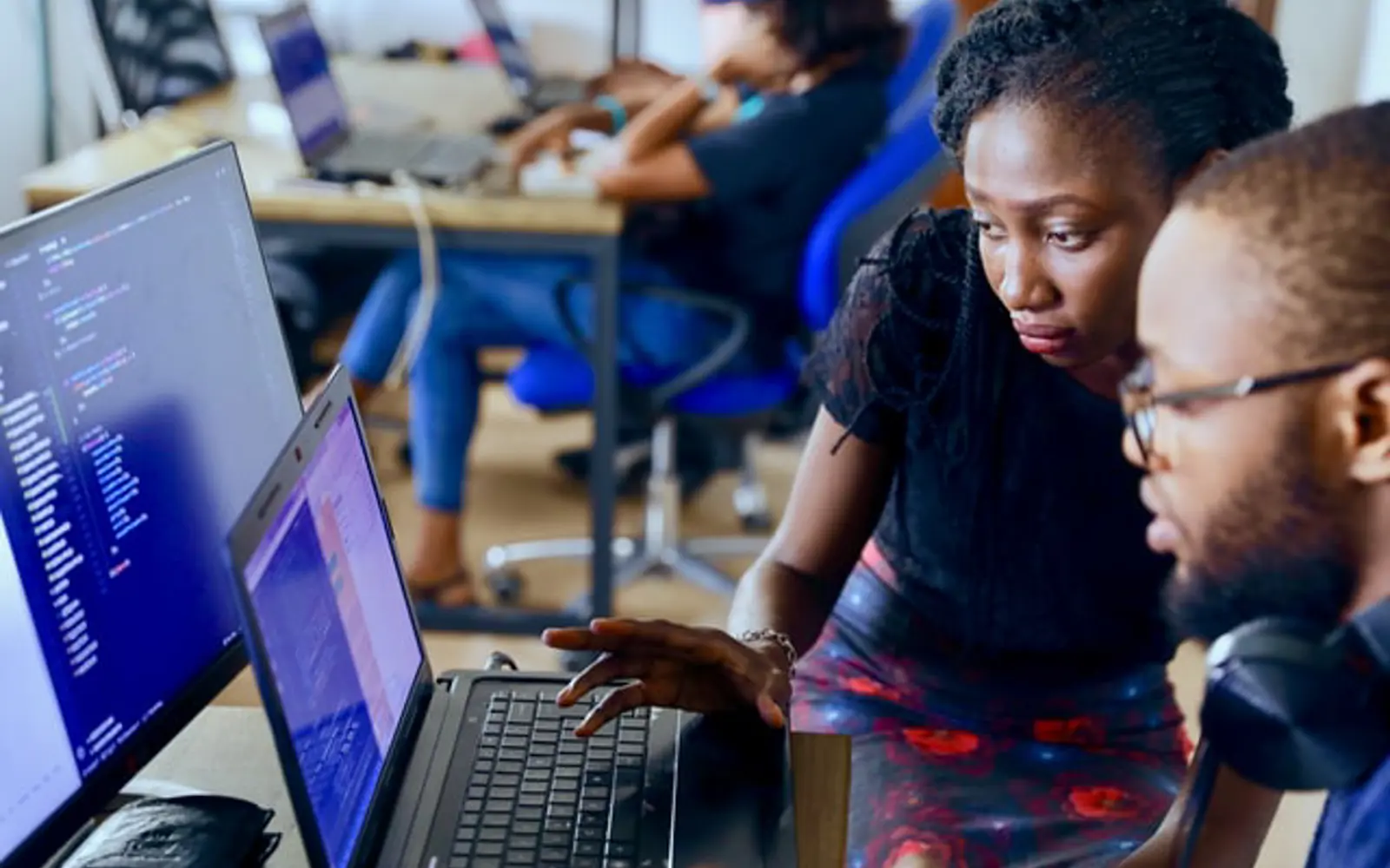 a woman looking at a laptop