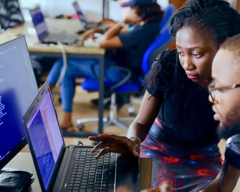a woman looking at a laptop