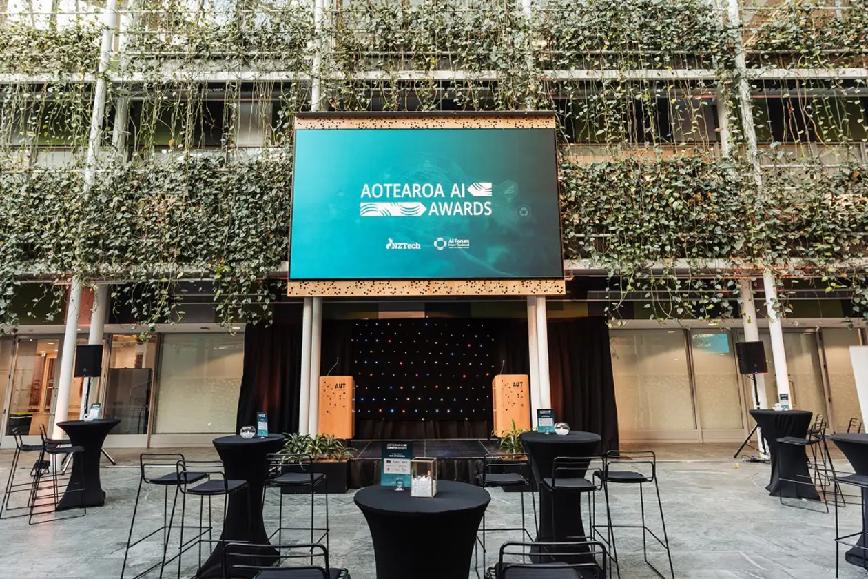 a stage with tables and chairs in front of a building