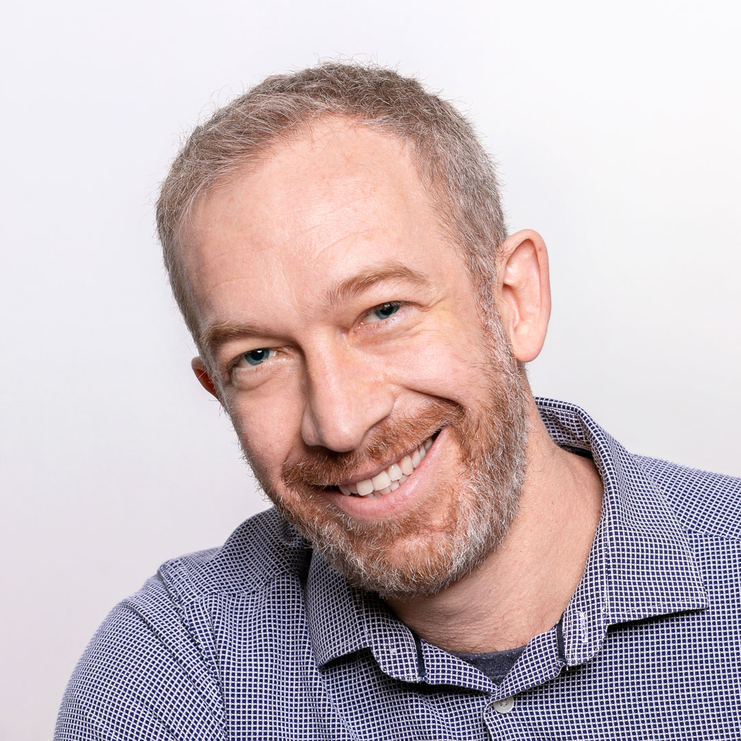 a man smiling at the camera