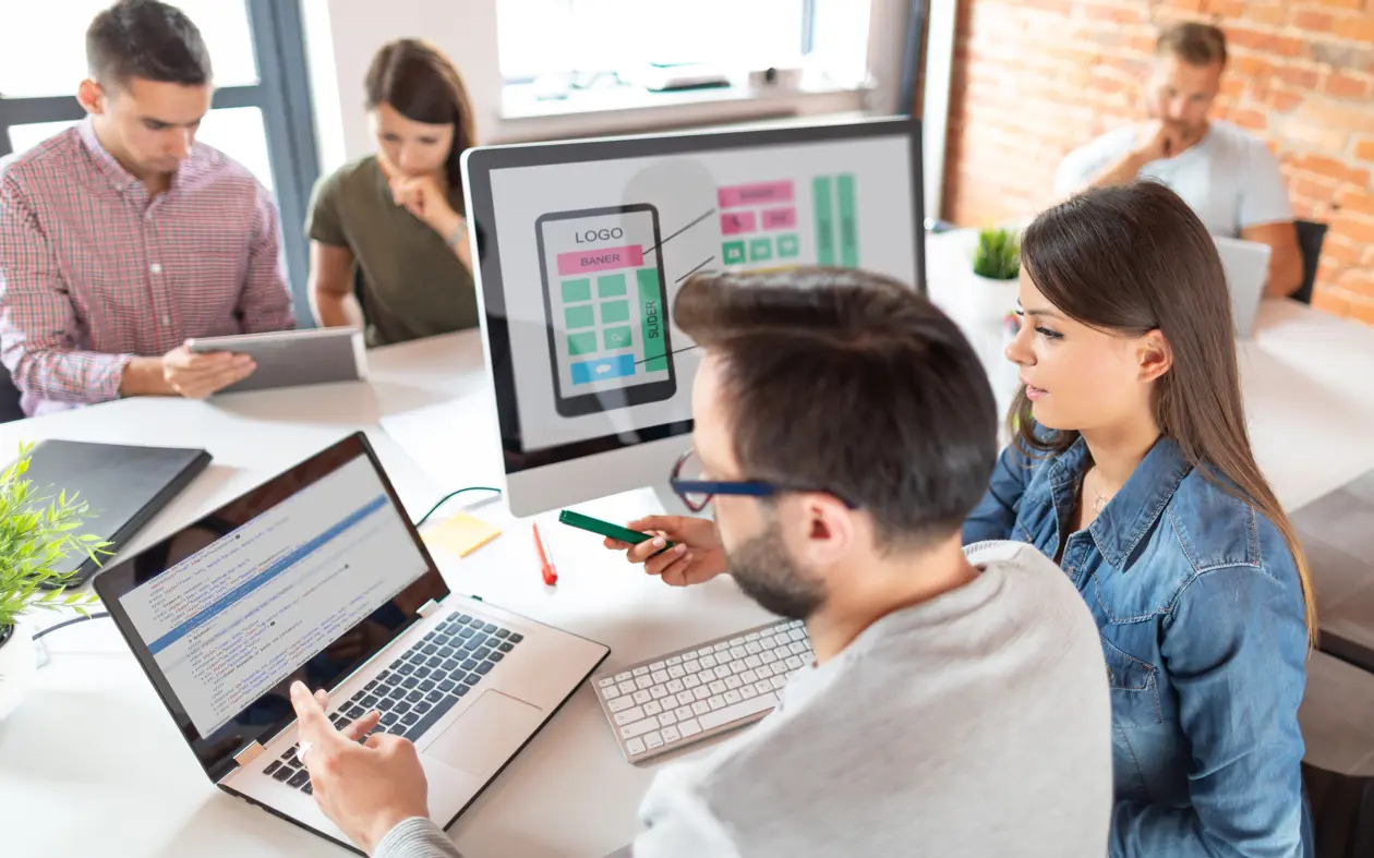 a group of people looking at computers