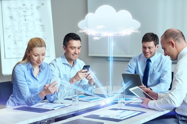 a group of people sitting at a table looking at a cloud