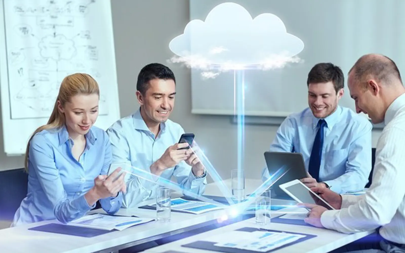 a group of people sitting at a table looking at a cloud