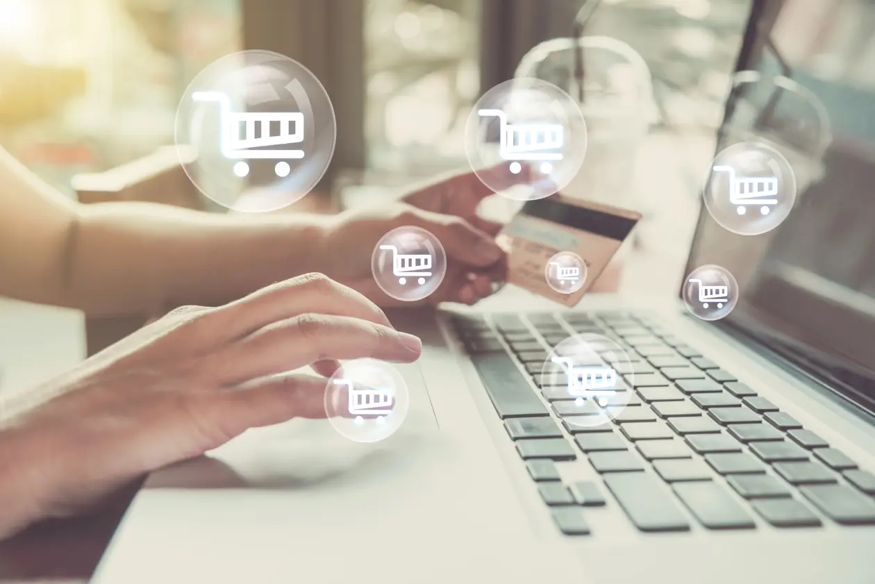 a person holding a credit card and using a laptop