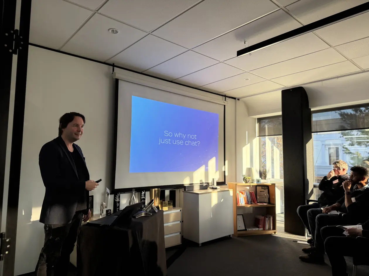 a man standing in front of a projector screen