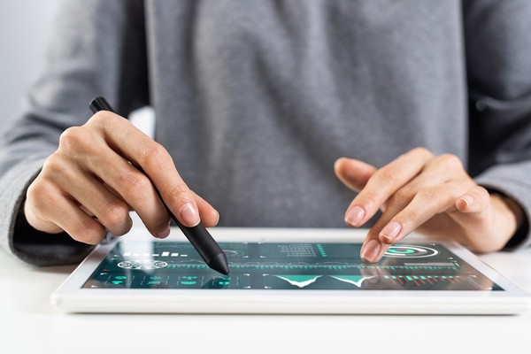 a person using a stylus on a tablet