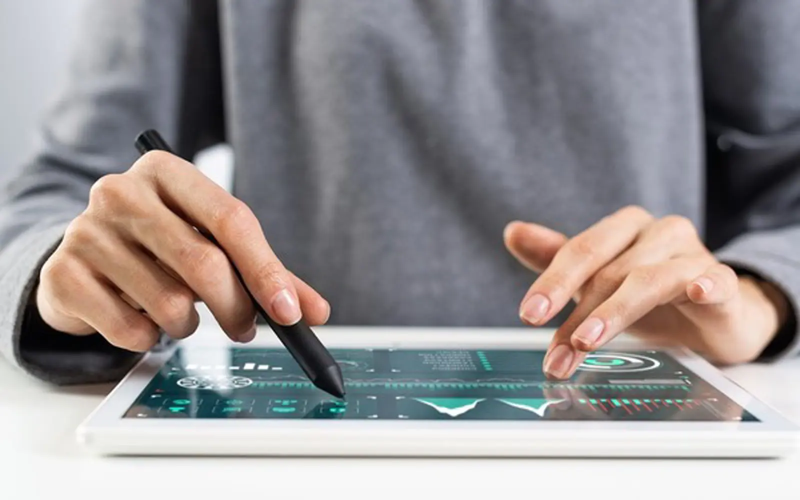 a person using a stylus on a tablet