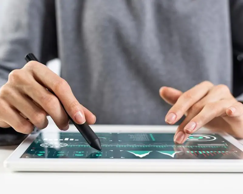 a person using a stylus on a tablet