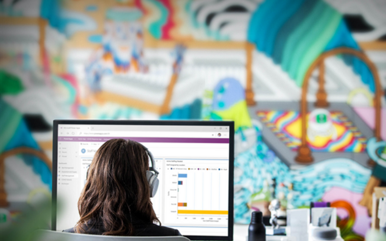 a woman wearing headphones looking at a computer screen