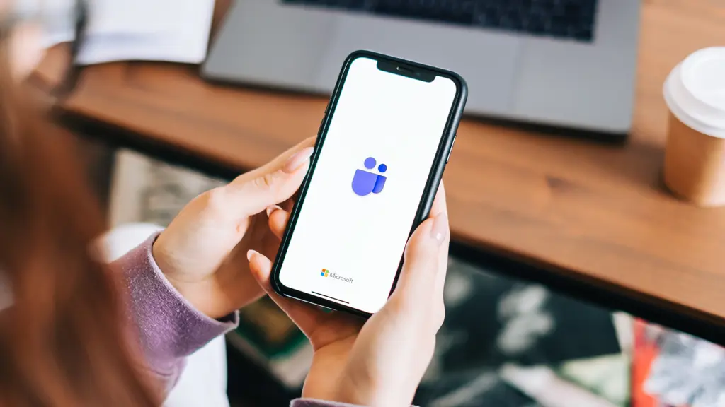 a person holding a phone using teams app