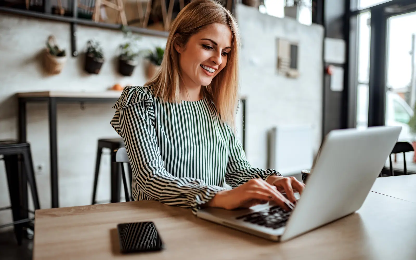 a woman using a laptop for customer journey strategy
