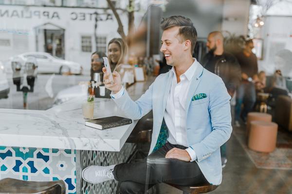a man sitting at a bar with a phone in his hand