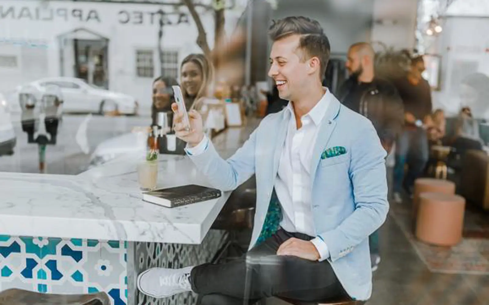 a man sitting at a bar with a phone in his hand