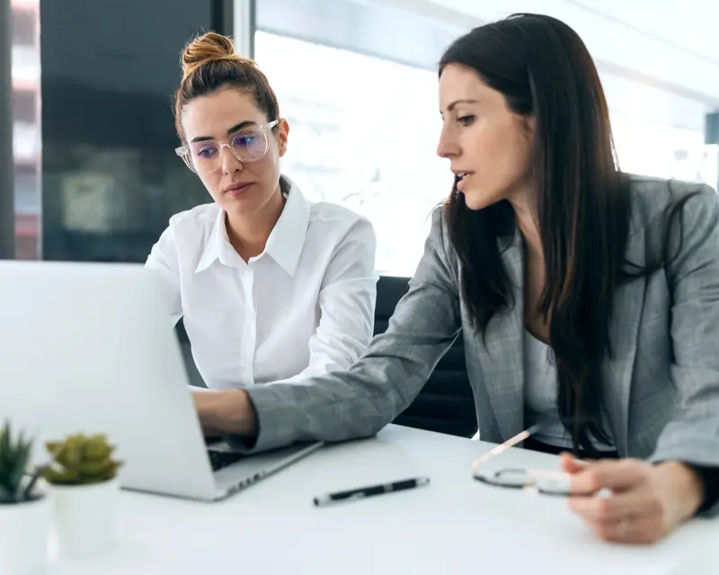 a woman looking at a laptop