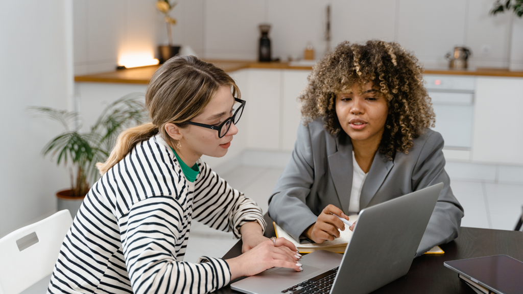two women looking at a laptop