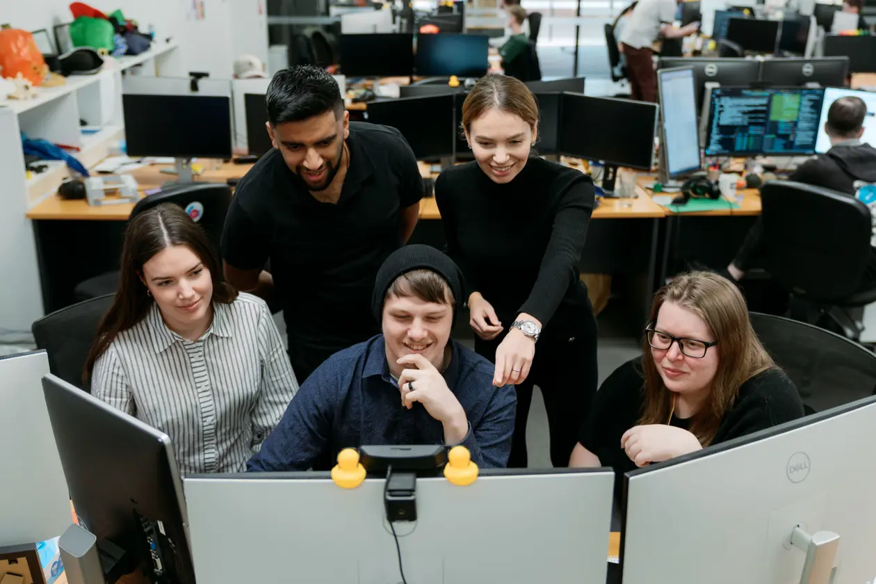 a group of people looking at a computer screen