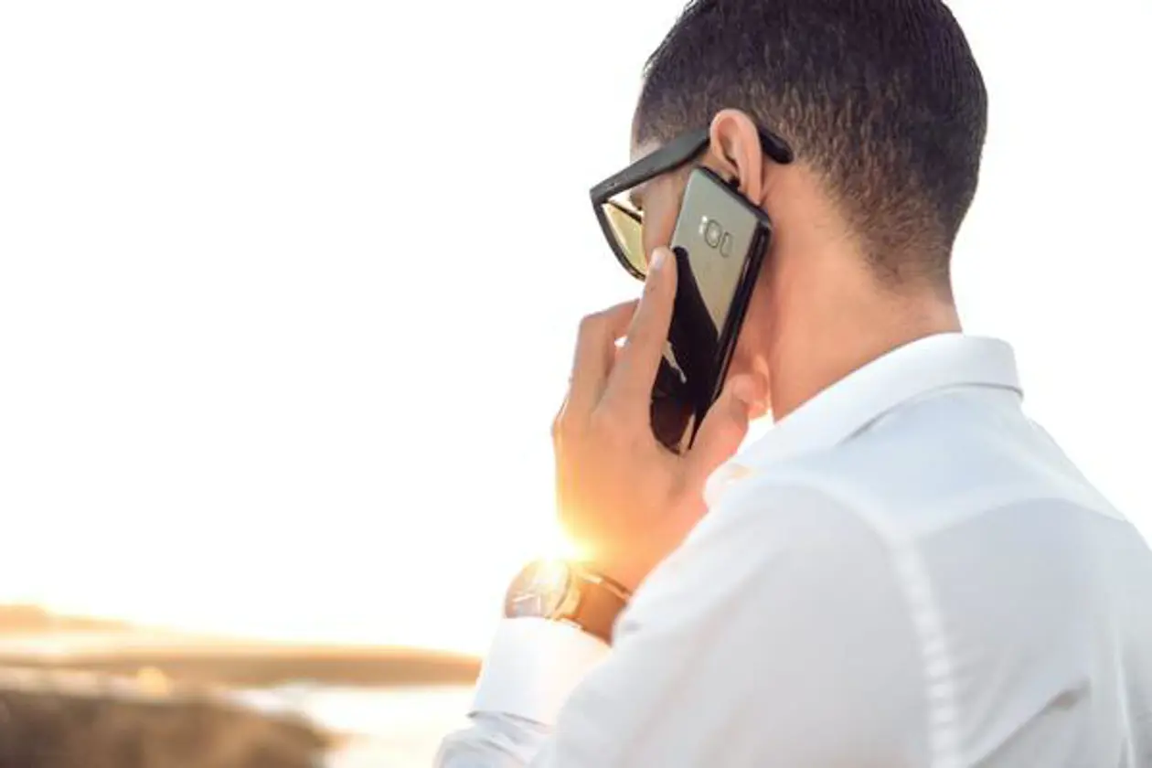 a man holding a cell phone to his ear