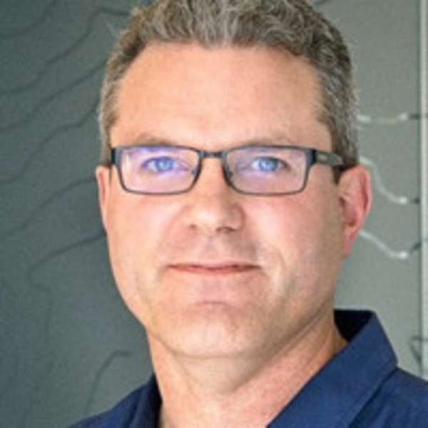 a man wearing glasses and a blue shirt