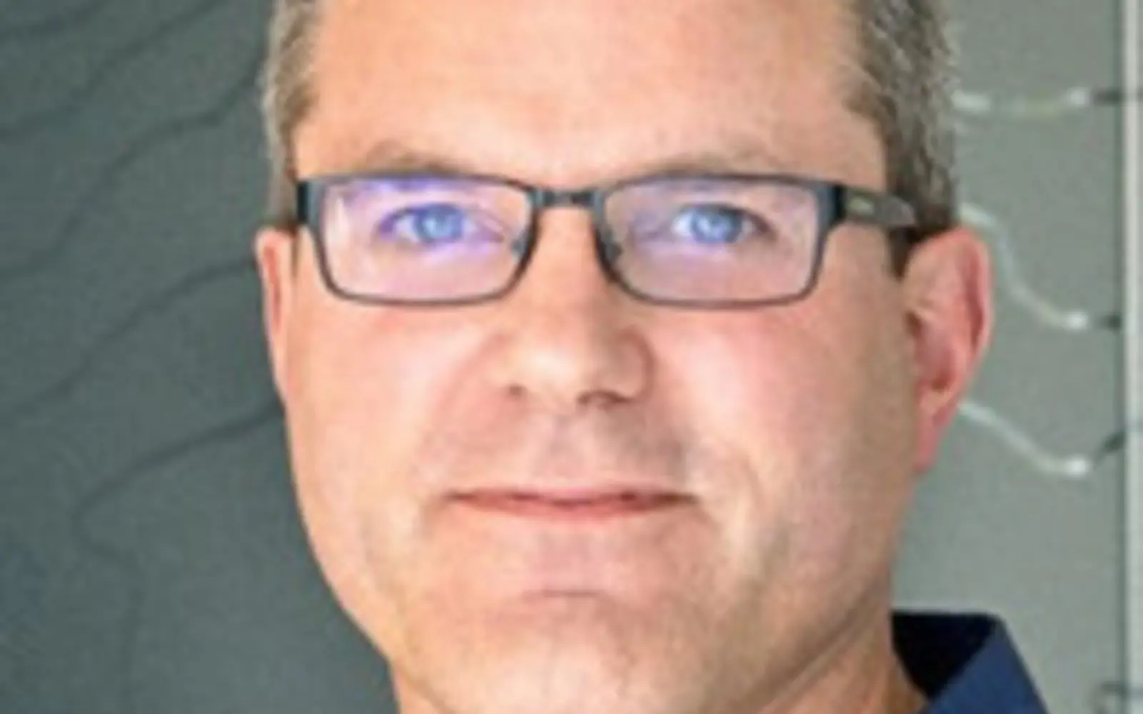 a man wearing glasses and a blue shirt