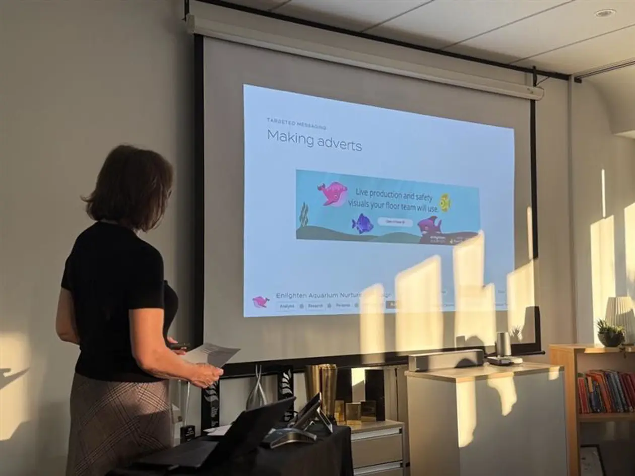 a woman standing in front of a projector screen