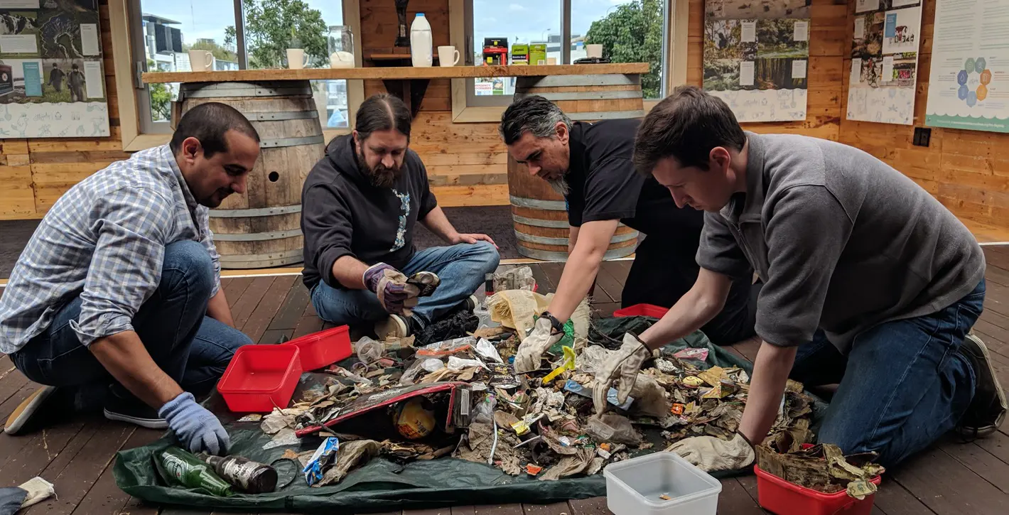 a group of men cleaning up trash