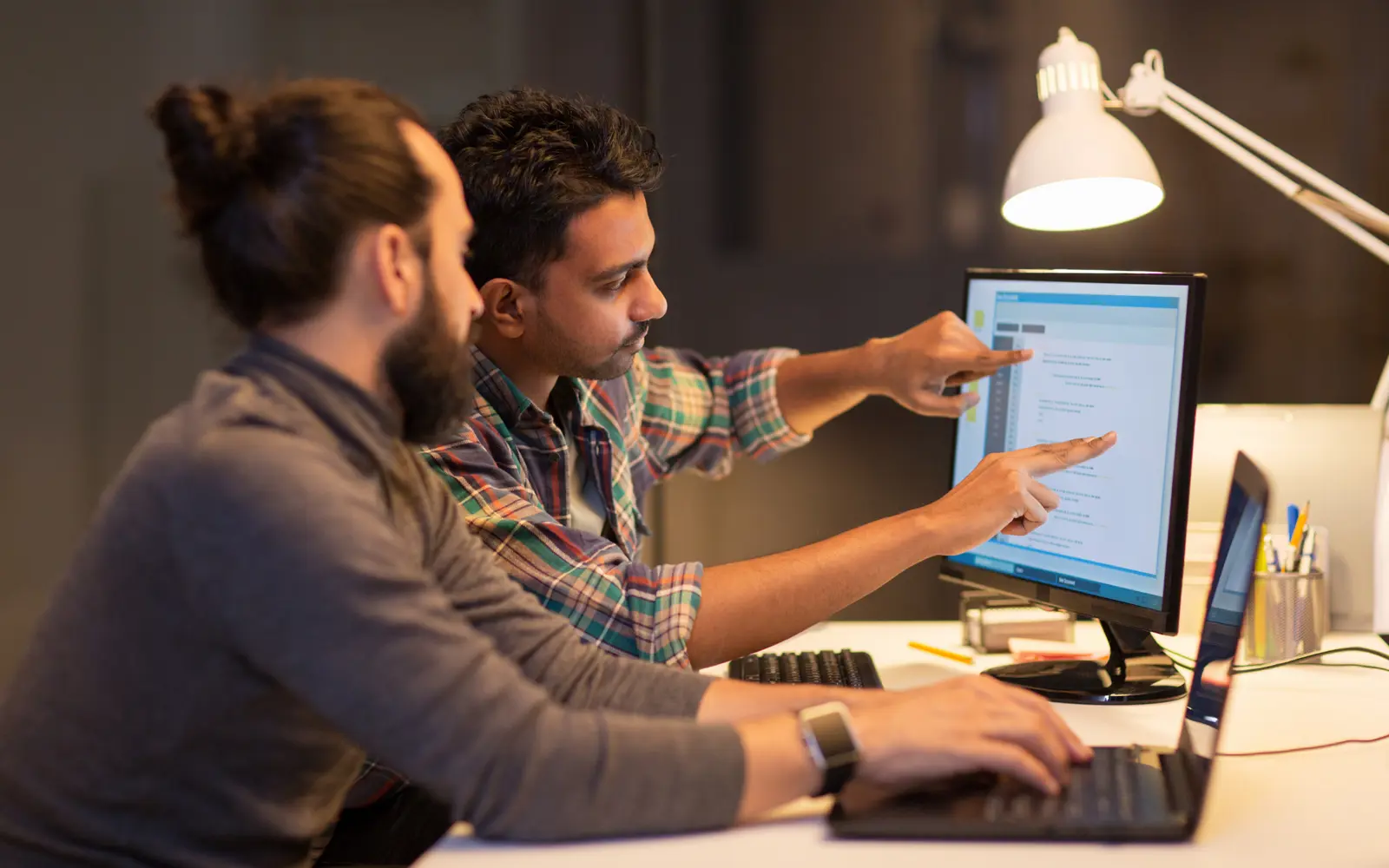 a man pointing at a computer screen