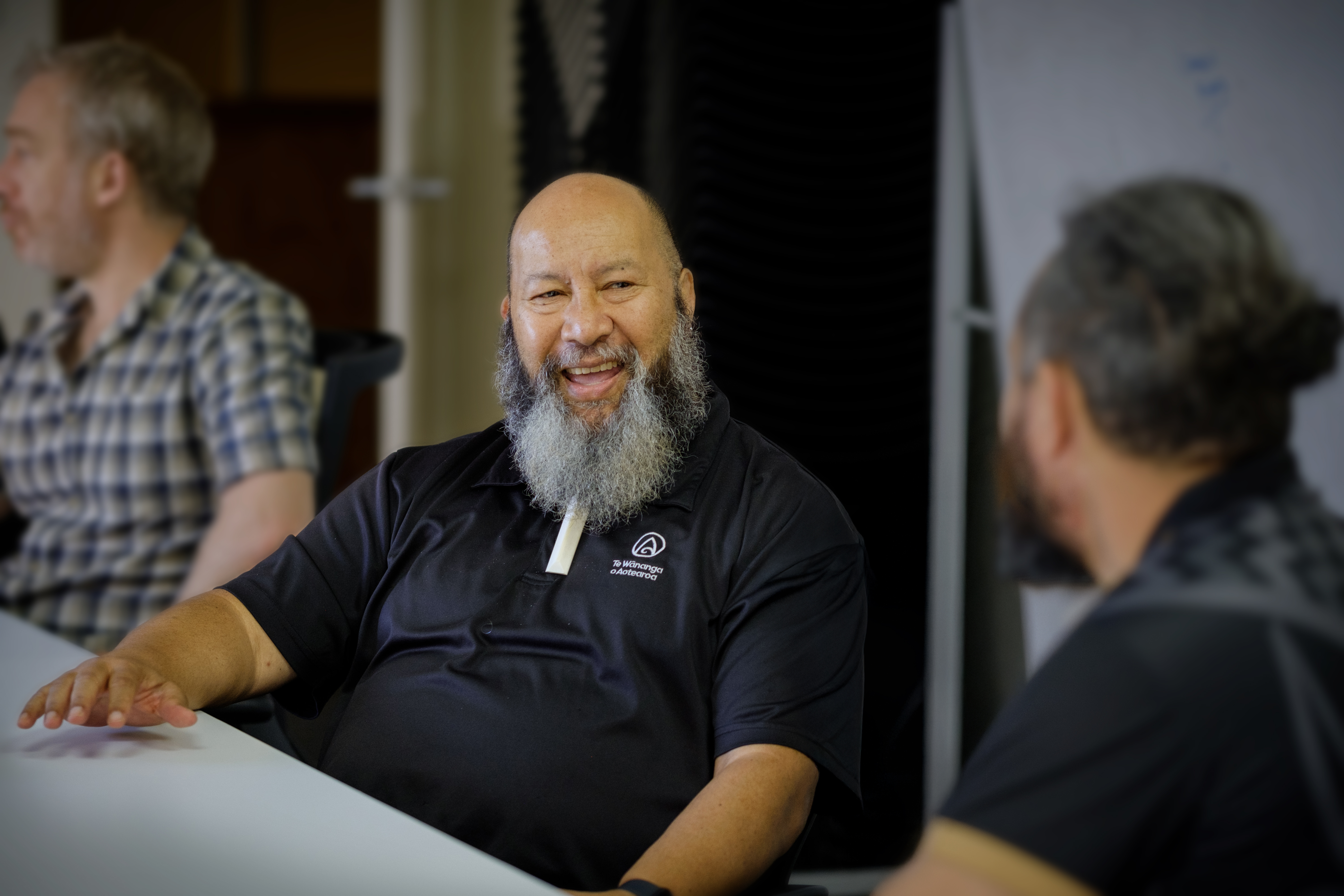a man with a beard sitting at a table