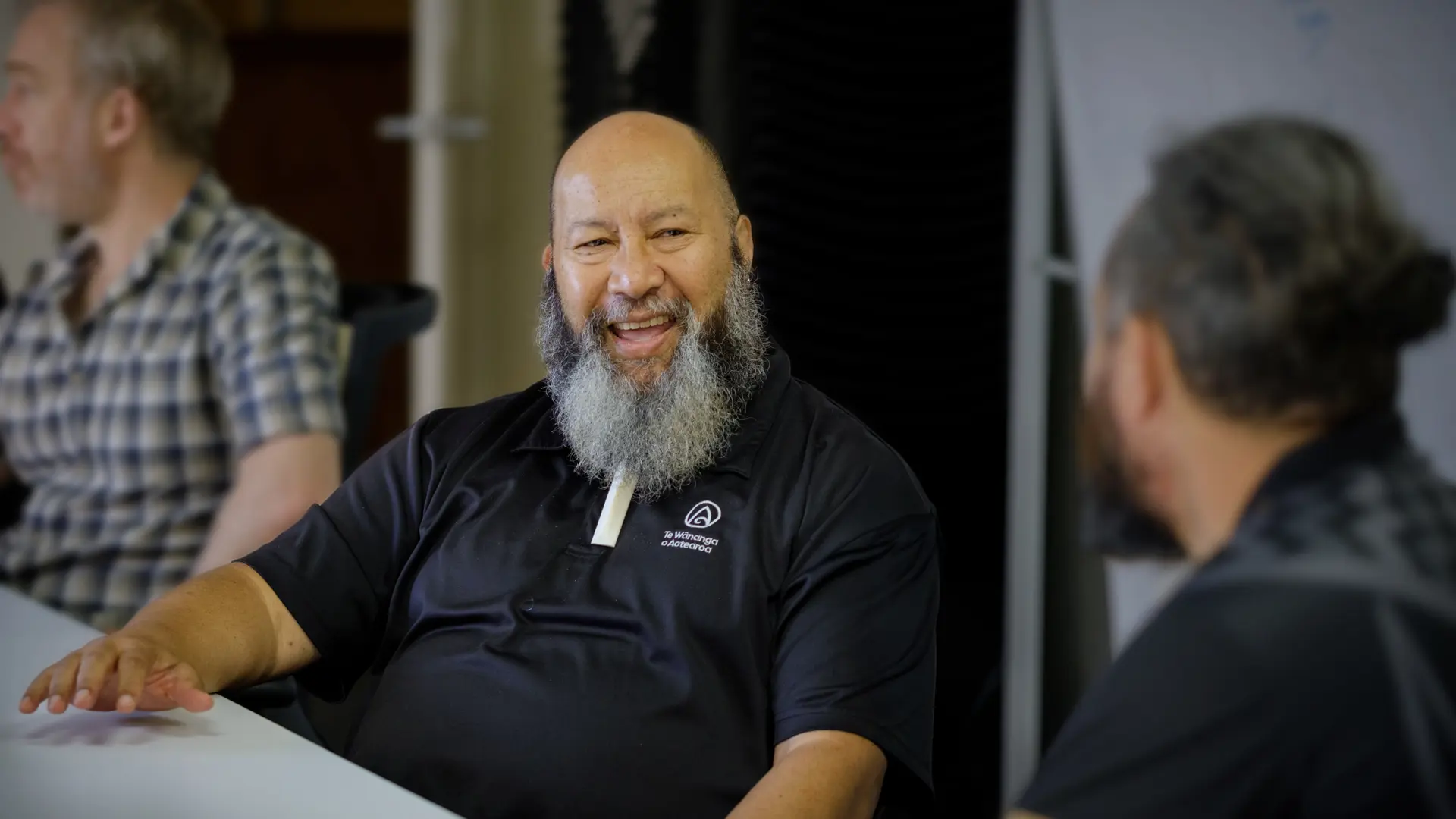 a man with a beard sitting at a table