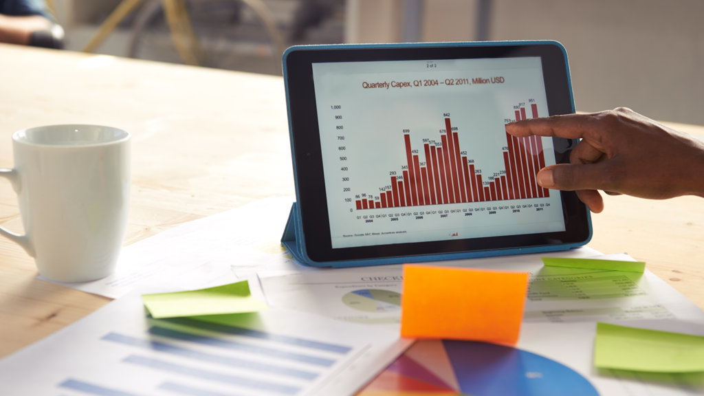 a hand pointing at a tablet