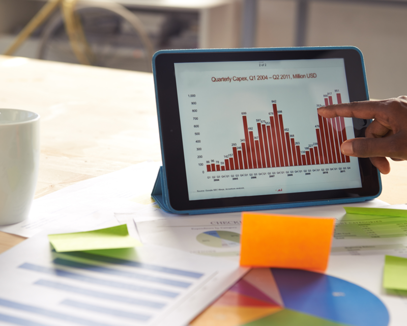 a hand pointing at a tablet