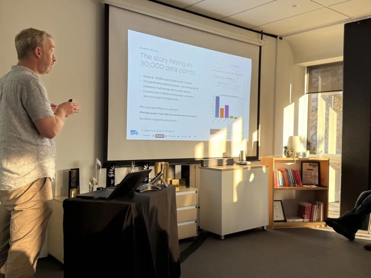 a man standing in front of a projector screen