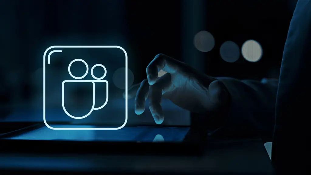 a hand touching a tablet with a glowing teams logo