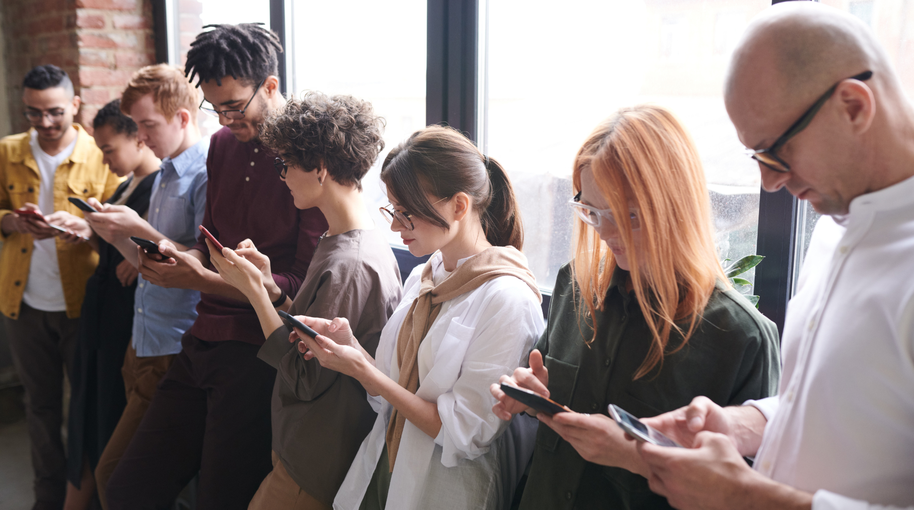 a group of people looking at their phones