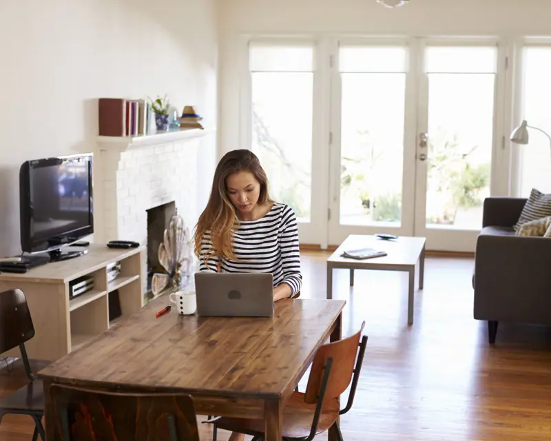 a woman working from home on a laptop